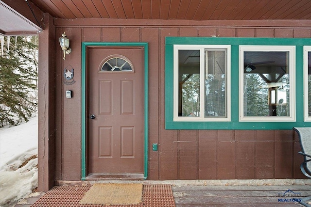 view of snow covered property entrance