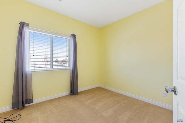 empty room with light carpet and baseboards