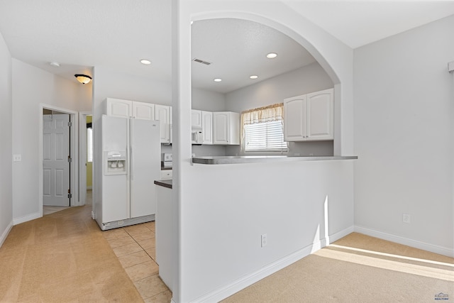 kitchen with recessed lighting, white appliances, white cabinetry, and light tile patterned floors