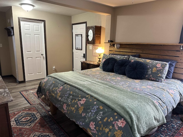 bedroom featuring wood finished floors