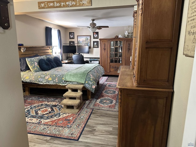 bedroom featuring a ceiling fan and wood finished floors