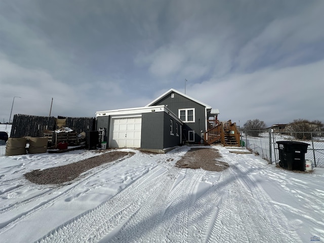 view of front of property with stairs, concrete block siding, and fence