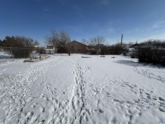 snowy yard with fence