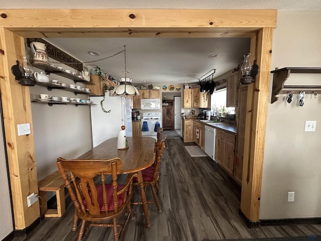 dining area featuring dark wood-style flooring and baseboards