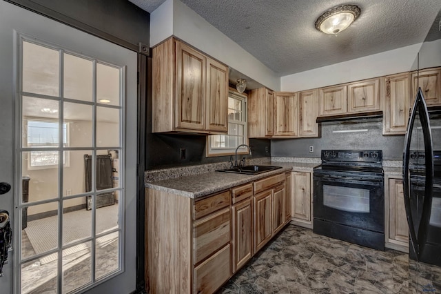 kitchen featuring a textured ceiling, black appliances, a sink, and under cabinet range hood