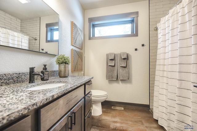 21268 Rubys Way, Lead, SD 57754 - full bath featuring curtained shower, toilet, vanity, visible vents, and baseboards