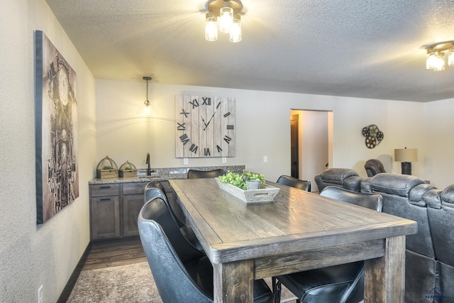 21268 Rubys Way, Lead, SD 57754 - dining space featuring a textured ceiling, dark wood-type flooring, indoor wet bar, and baseboards