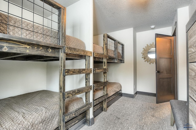 21268 Rubys Way, Lead, SD 57754 - bedroom featuring carpet, a textured ceiling, and baseboards