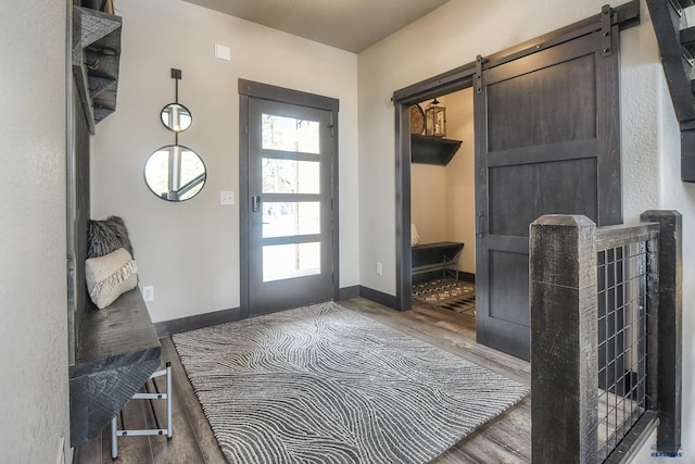 21268 Rubys Way, Lead, SD 57754 - mudroom featuring a barn door, wood finished floors, and baseboards