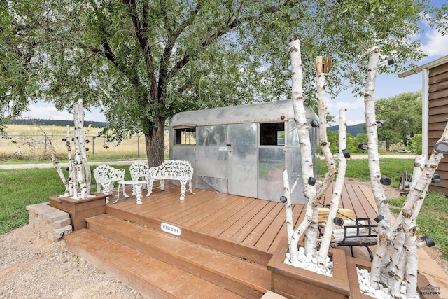 wooden terrace with an outbuilding