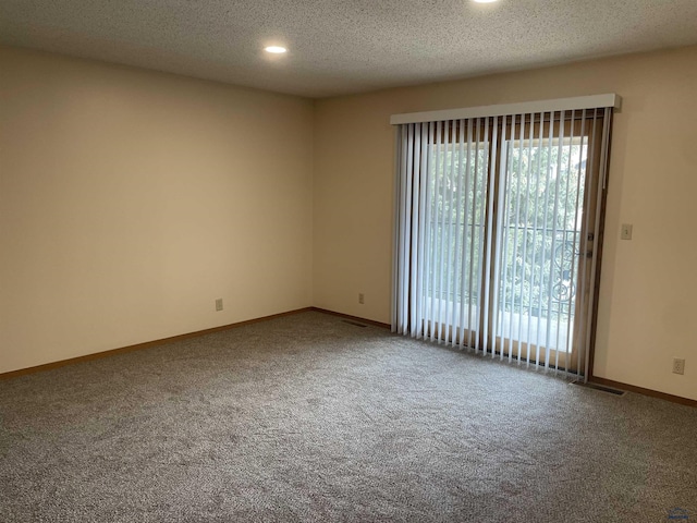 spare room with carpet, plenty of natural light, and baseboards