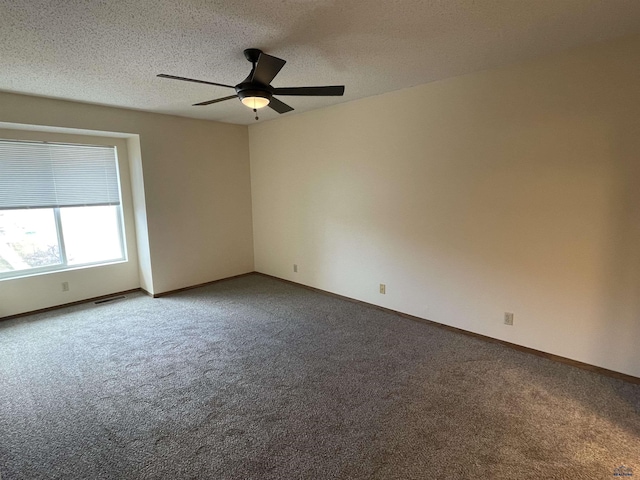 unfurnished room featuring a textured ceiling, carpet, visible vents, and baseboards