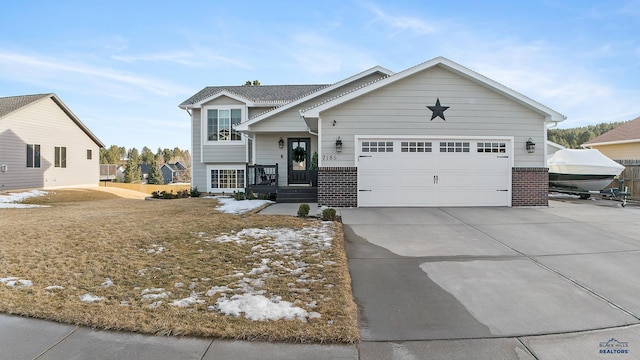 view of front of home with brick siding, driveway, and an attached garage