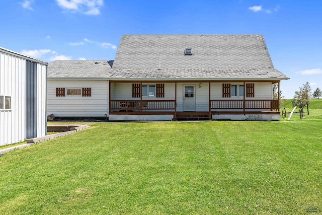 back of house with a yard, a shingled roof, and a wooden deck