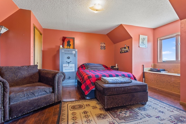 bedroom featuring a textured ceiling and wood finished floors