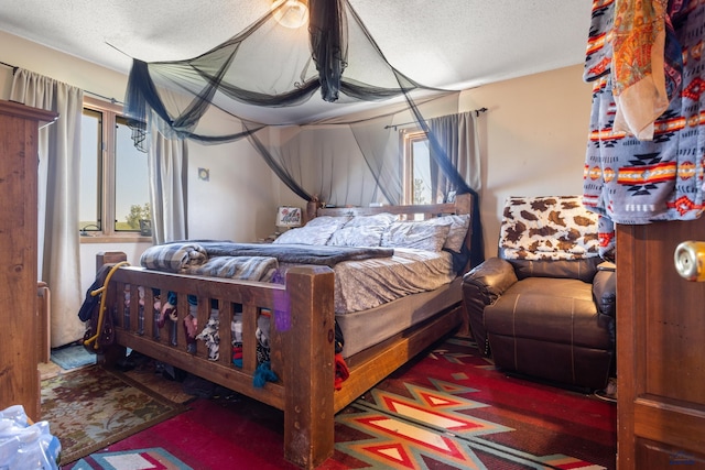 bedroom with multiple windows and a textured ceiling