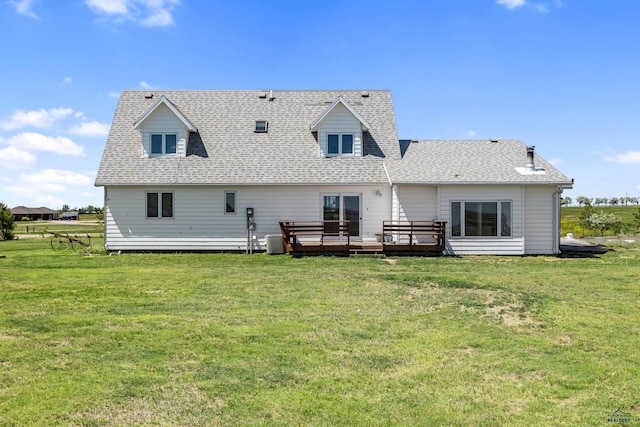 rear view of property featuring central air condition unit, a shingled roof, a lawn, and a wooden deck