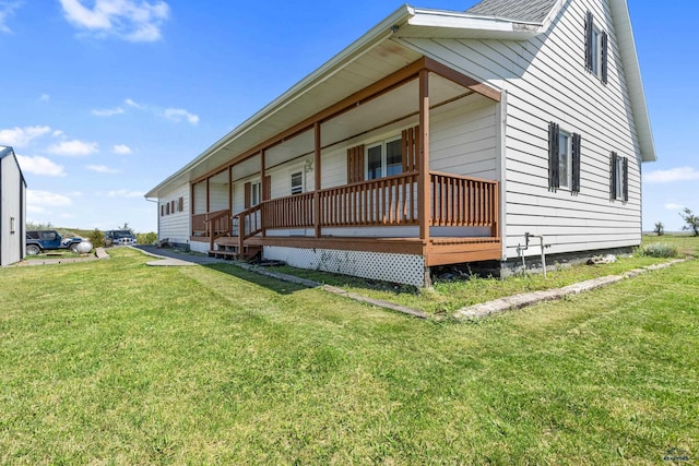 view of home's exterior with a porch and a lawn