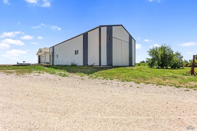 view of pole building with a garage and a lawn