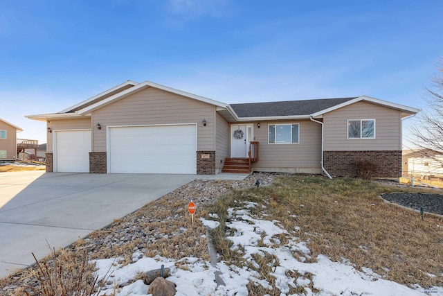 ranch-style home featuring a garage, concrete driveway, and brick siding