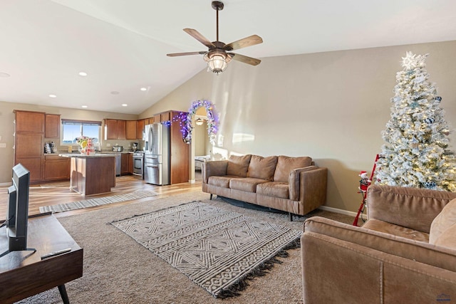 living area featuring a ceiling fan, lofted ceiling, baseboards, and recessed lighting