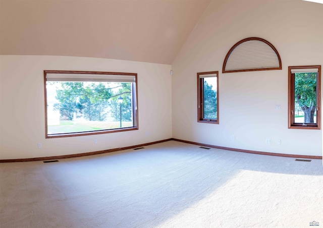 spare room featuring high vaulted ceiling, carpet, visible vents, and baseboards