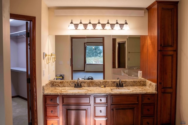 full bathroom featuring a closet, a sink, and double vanity