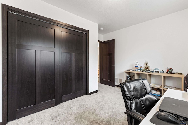 home office featuring light carpet, baseboards, and visible vents