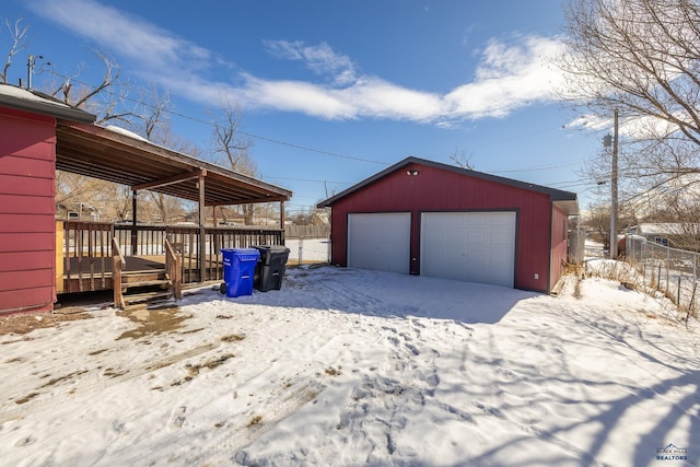 snow covered garage featuring a garage