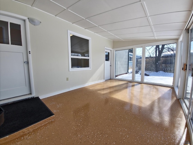 interior space with speckled floor, a paneled ceiling, and baseboards