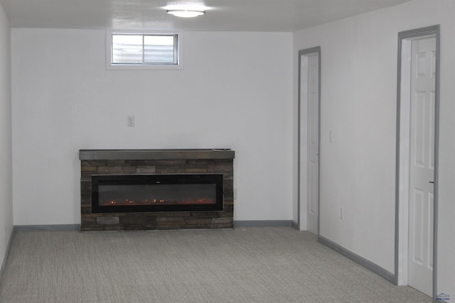 room details with a fireplace, carpet flooring, and baseboards