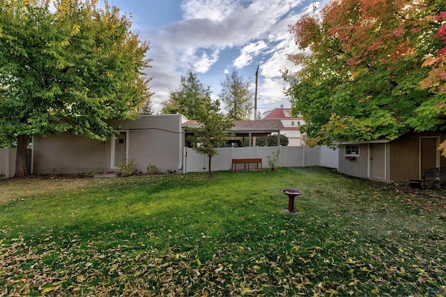 view of yard featuring an outbuilding and a fenced backyard