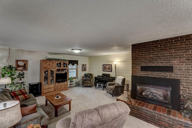 carpeted living area with a brick fireplace, a wall mounted air conditioner, and a textured ceiling