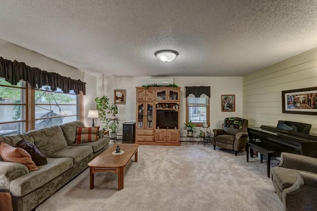 living room with light carpet, a textured ceiling, a wealth of natural light, and a wall mounted air conditioner