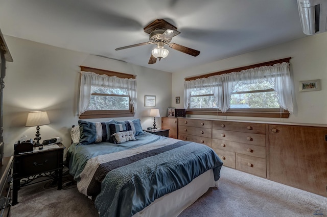 bedroom with a ceiling fan and light colored carpet