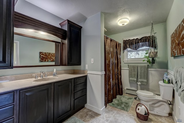 full bath featuring baseboards, toilet, baseboard heating, a textured ceiling, and vanity