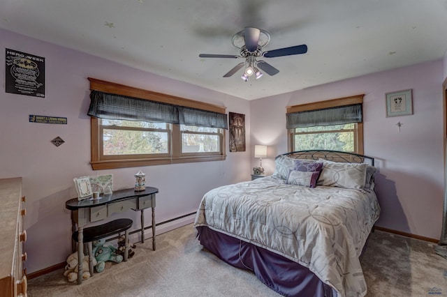 carpeted bedroom with ceiling fan and baseboards