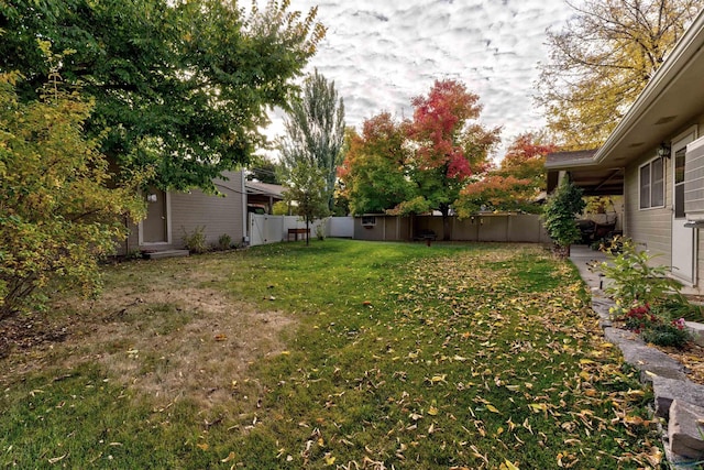 view of yard featuring entry steps and a fenced backyard