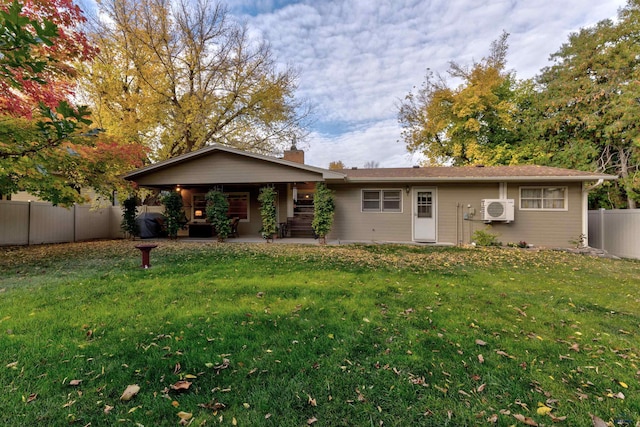 view of front of property with a patio, a chimney, a front yard, and fence