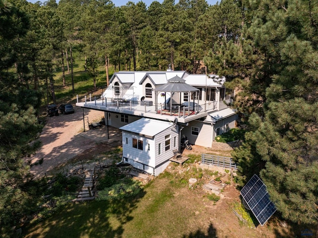 birds eye view of property with a view of trees