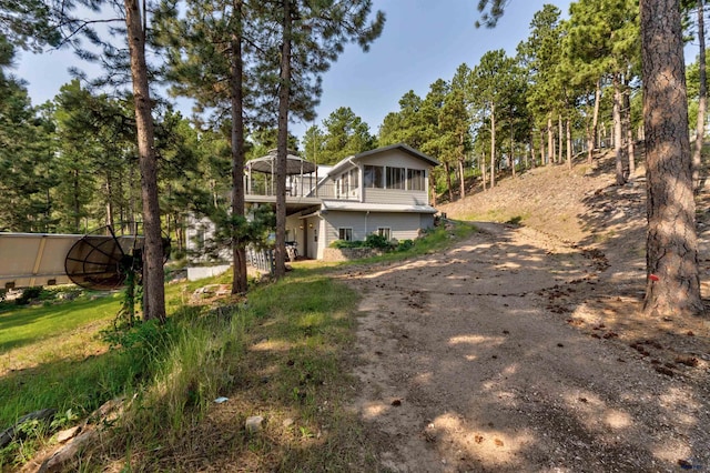 view of front of house featuring driveway and a wooden deck