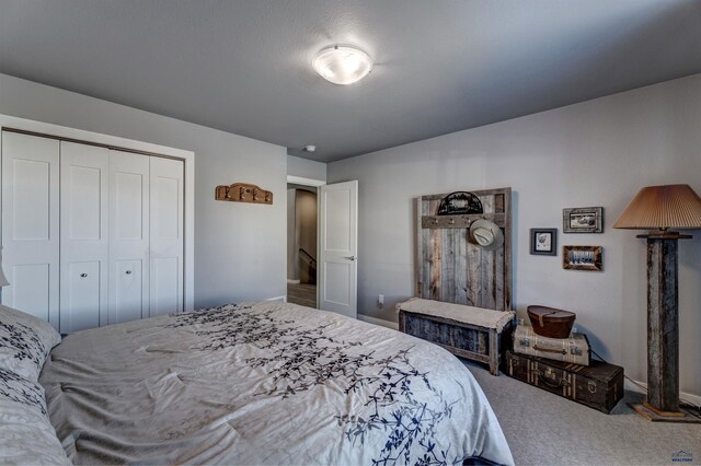 carpeted bedroom with a closet