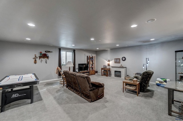 living area featuring recessed lighting, a fireplace, baseboards, and light colored carpet