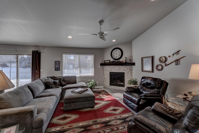 living room featuring ceiling fan, a stone fireplace, recessed lighting, and a healthy amount of sunlight