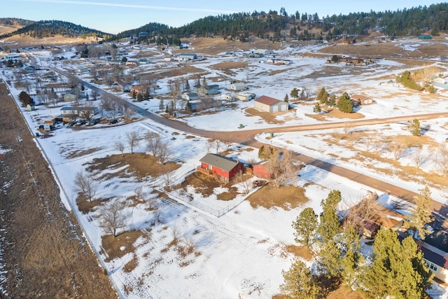 snowy aerial view featuring a residential view