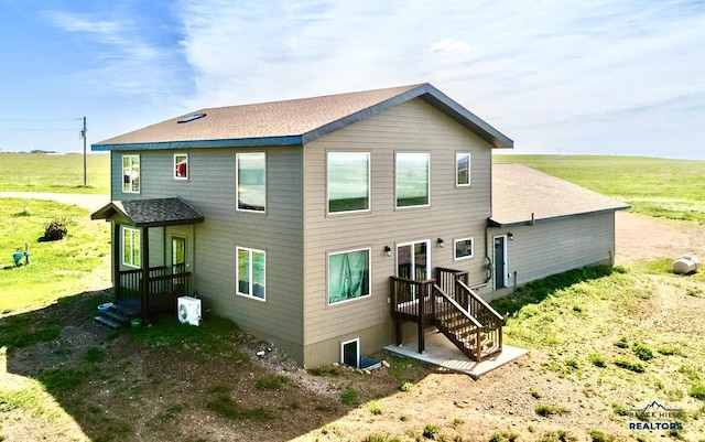 back of property featuring a shingled roof