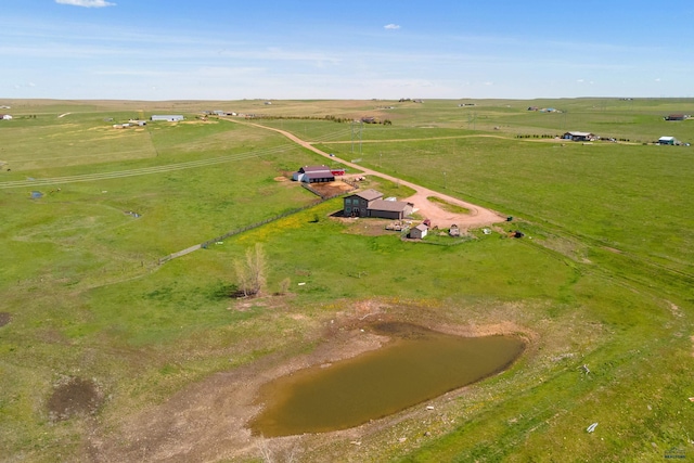 birds eye view of property with a water view and a rural view