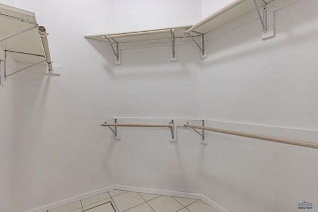 spacious closet featuring light tile patterned floors