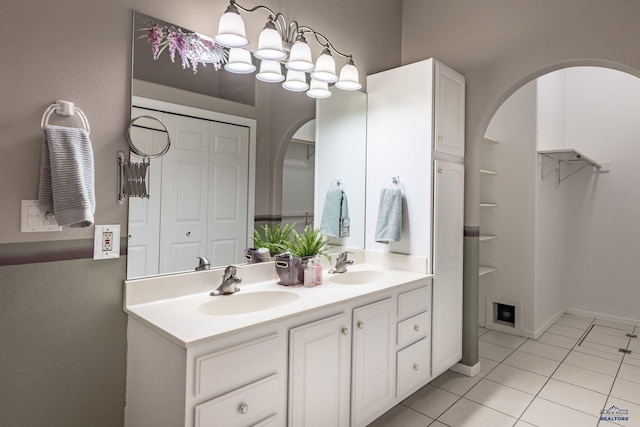 bathroom with tile patterned flooring, a closet, a sink, and double vanity