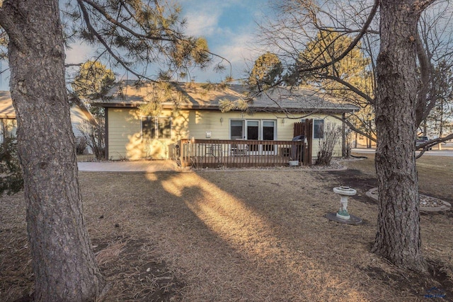 view of front facade with a patio area and a wooden deck